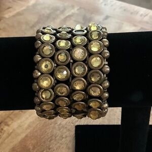 Vintage inspired stretch bracelet with gold tones and gemstone accents.